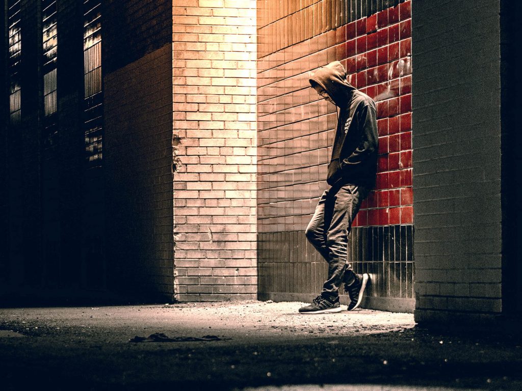 Lonely Man Standing in Alleyway